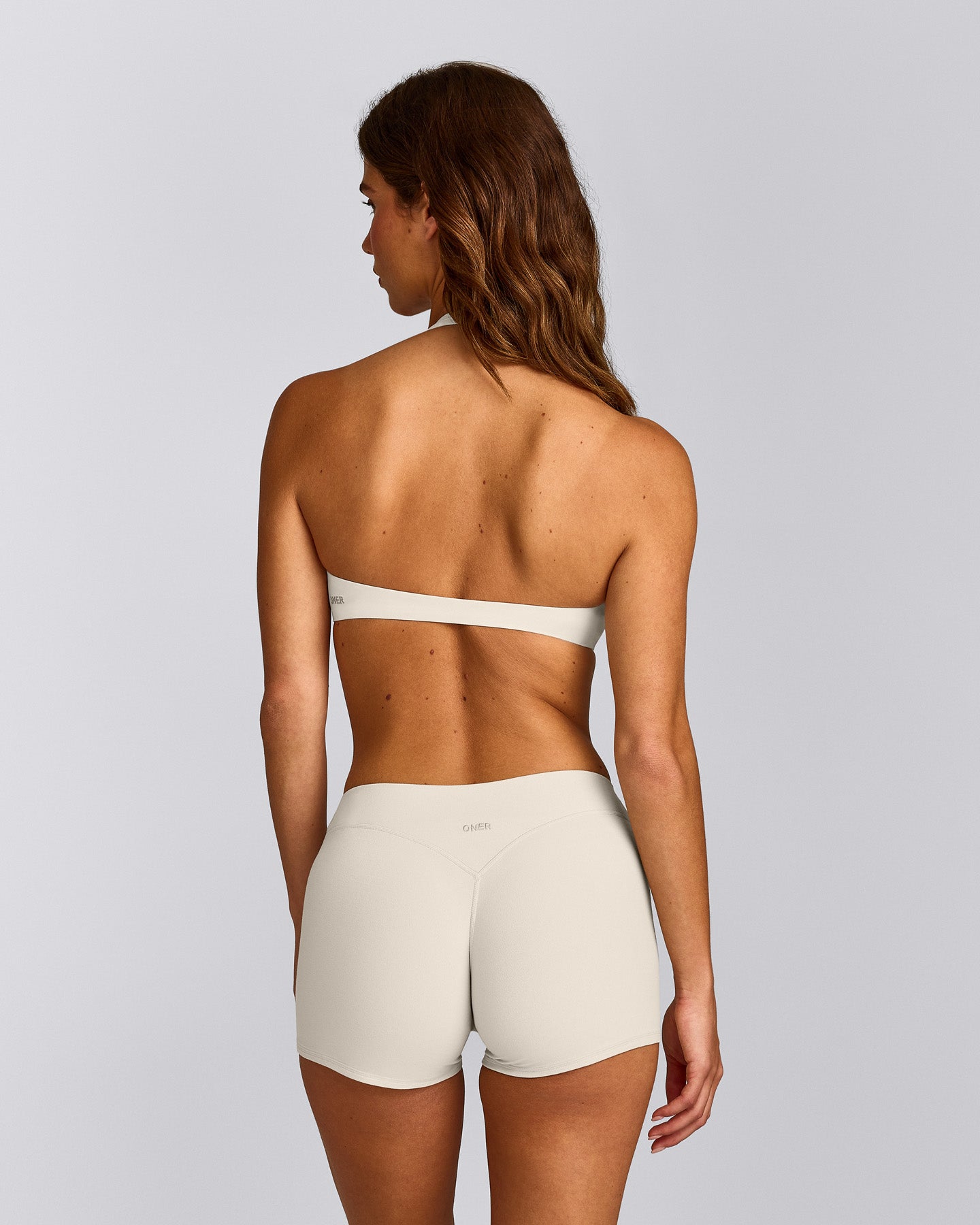 SoftMotion™ Minimal Halter Neck Bralette with Gray Logo | Marshmallow White