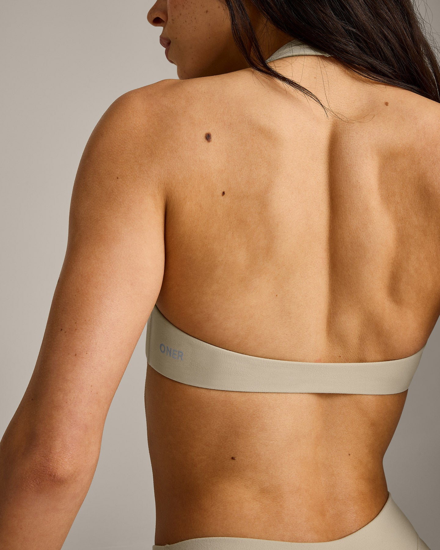 SoftMotion™ Minimal Halter Neck Bralette with Gray Logo | Oatmeal
