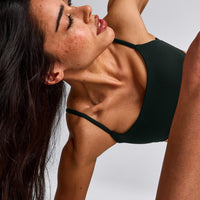 SoftMotion™ Strappy Sports Bra with Gray Logo | Emerald Noir