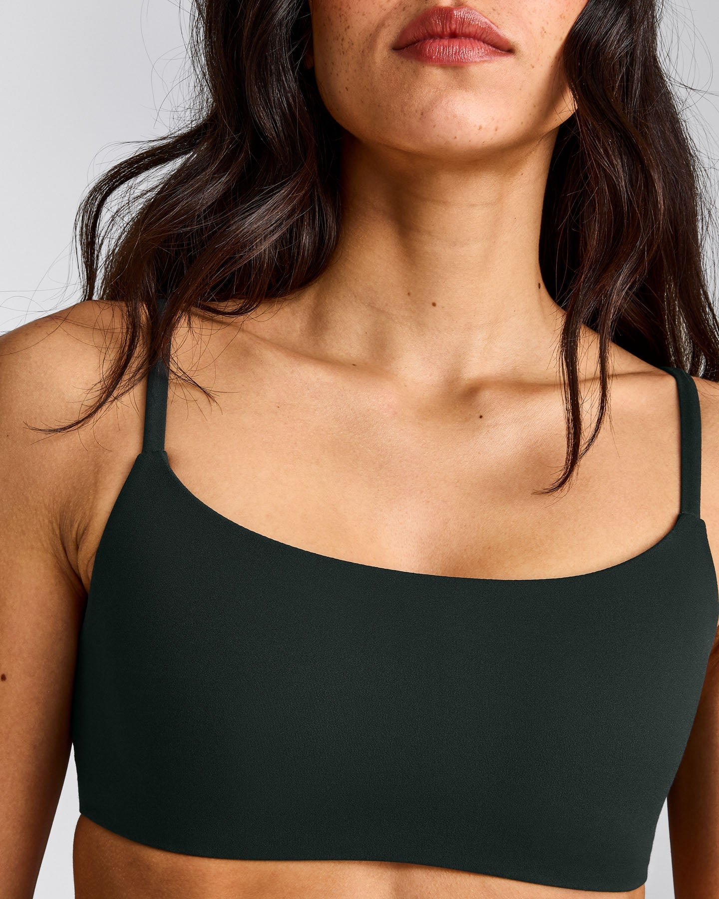 SoftMotion™ Strappy Sports Bra with Gray Logo | Emerald Noir