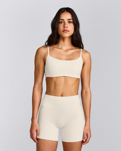 SoftMotion™ Strappy Sports Bra with Gray Logo | Marshmallow White