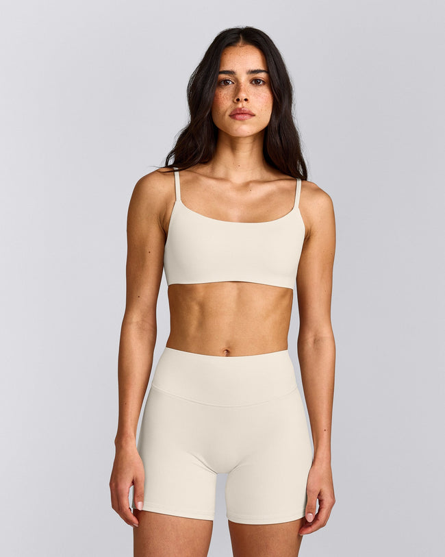 SoftMotion™ Strappy Sports Bra with Gray Logo | Marshmallow White