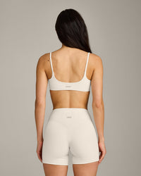 SoftMotion™ Strappy Sports Bra with Gray Logo | Marshmallow White