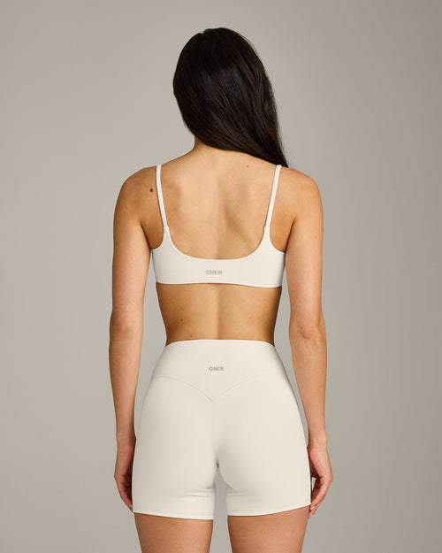 SoftMotion™ Strappy Sports Bra with Gray Logo | Marshmallow White