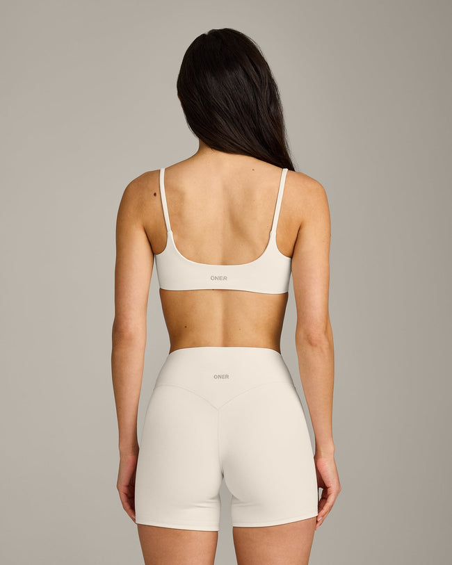 SoftMotion™ Strappy Sports Bra with Gray Logo | Marshmallow White