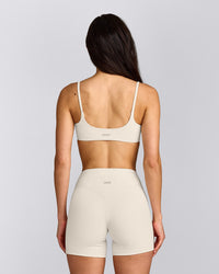 SoftMotion™ Strappy Sports Bra with Gray Logo | Marshmallow White