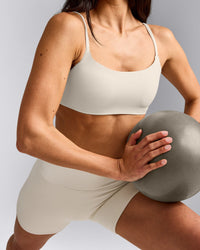 SoftMotion™ Strappy Sports Bra with Gray Logo | Marshmallow White