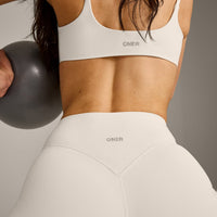 SoftMotion™ Strappy Sports Bra with Gray Logo | Marshmallow White