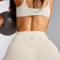 SoftMotion™ Strappy Sports Bra with Gray Logo | Marshmallow White