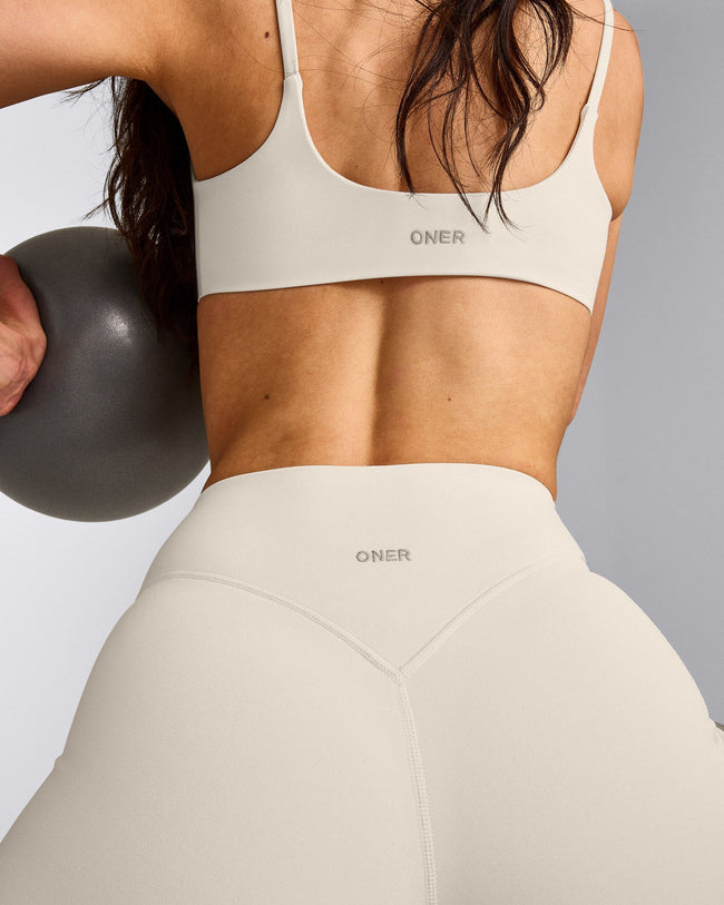 SoftMotion™ Strappy Sports Bra with Gray Logo | Marshmallow White