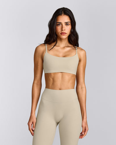 SoftMotion™ Strappy Sports Bra with Gray Logo | Oatmeal