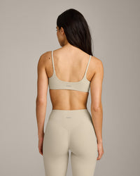 SoftMotion™ Strappy Sports Bra with Gray Logo | Oatmeal