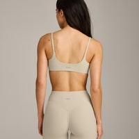 SoftMotion™ Strappy Sports Bra with Gray Logo | Oatmeal