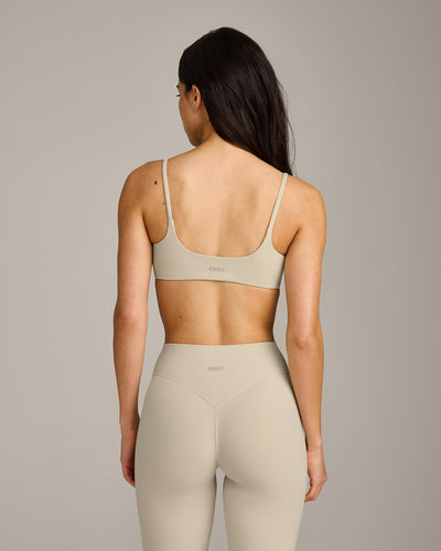 SoftMotion™ Strappy Sports Bra with Gray Logo | Oatmeal
