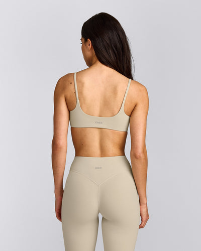 SoftMotion™ Strappy Sports Bra with Gray Logo | Oatmeal
