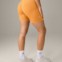 EffortlessLift™ Seamless Mid Rise Shorts with Gray Logo | Powdered Orange
