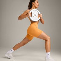 EffortlessLift™ Seamless Mid Rise Shorts with Gray Logo | Powdered Orange