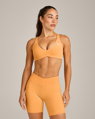 UnifiedMove™ Cross Back Sports Bra with Reflective Logo | Powdered Orange
