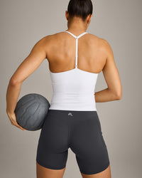 UnifiedMove™ T Back Mid Tank Top with Built in Bra Shelf with Reflective Logo | White