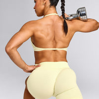 EnhanceLift™ Seamless Minimal Halter Neck Bralette with Gray Logo | Pastel Yellow