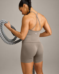 EnhanceLift™ Seamless Strappy Racer Tank Top with Built in Bra Shelf with Gray Logo | Warm Minky
