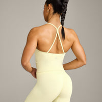 EnhanceLift™ Seamless Strappy Racer Tank Top with Built in Bra Shelf with Gray Logo | Pastel Yellow
