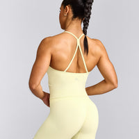 EnhanceLift™ Seamless Strappy Racer Tank Top with Built in Bra Shelf with Gray Logo | Pastel Yellow