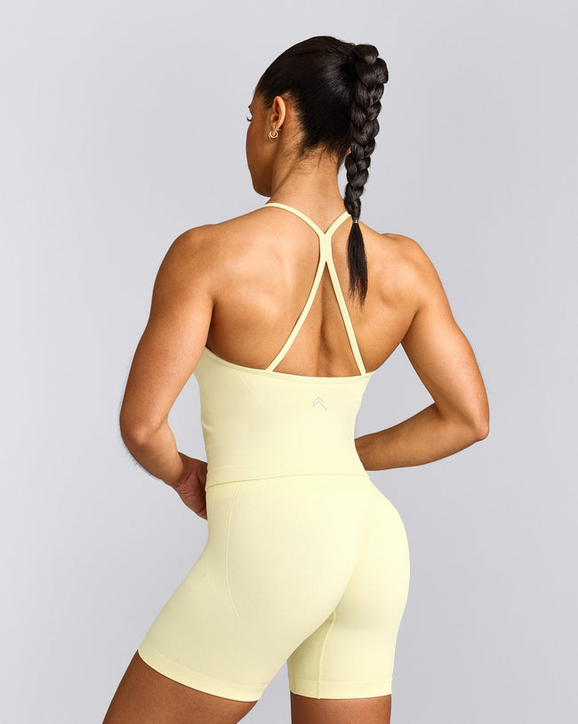EnhanceLift™ Seamless Strappy Racer Tank Top with Built in Bra Shelf with Gray Logo | Pastel Yellow