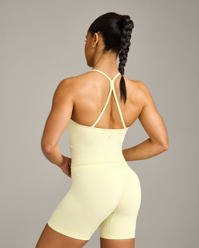 EnhanceLift™ Seamless Strappy Racer Tank Top with Built in Bra Shelf with Gray Logo | Pastel Yellow