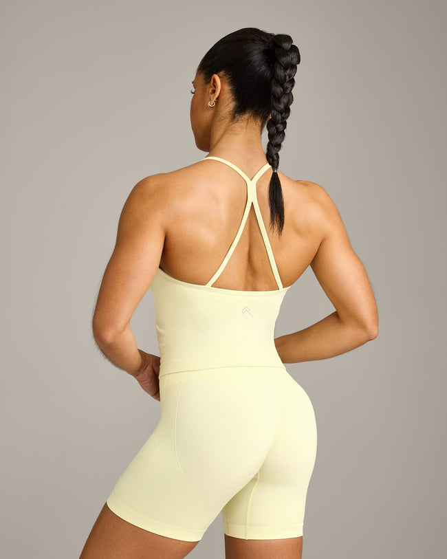 EnhanceLift™ Seamless Strappy Racer Tank Top with Built in Bra Shelf with Gray Logo | Pastel Yellow