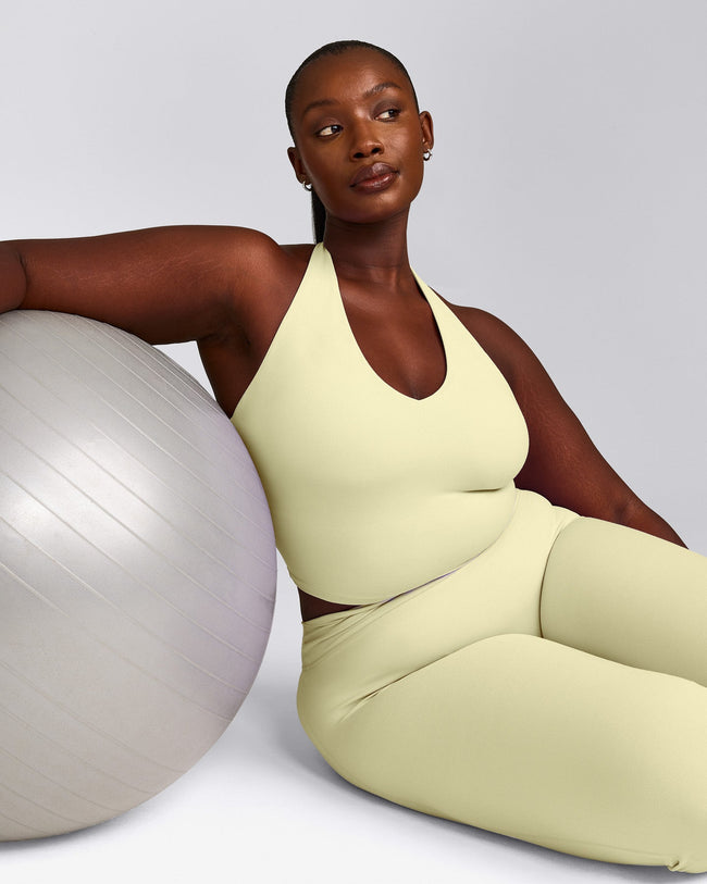 SoftMotion™ Halter Neck Mid Tank Top with Built in Bra Shelf with Gray Logo | Pastel Yellow