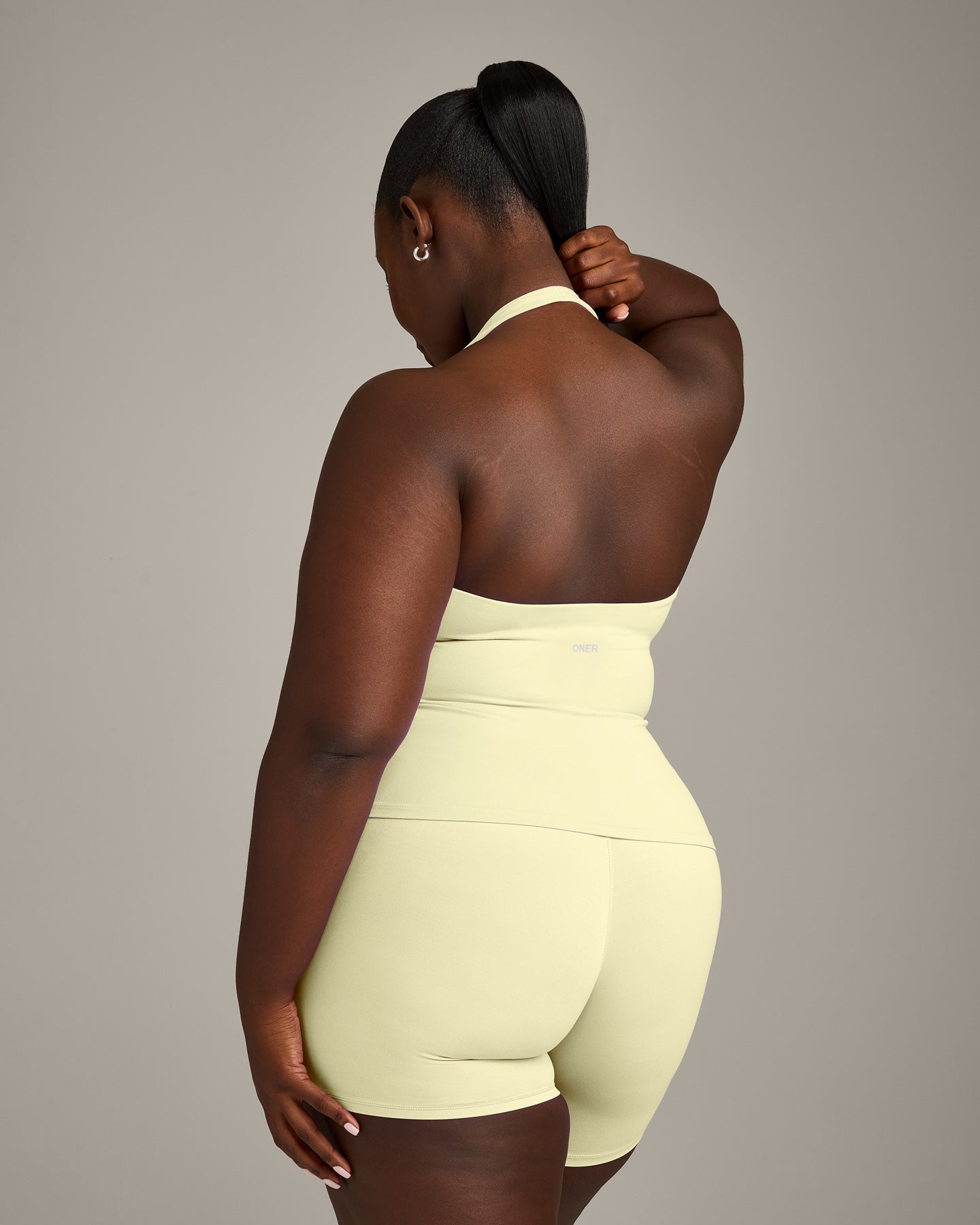 SoftMotion™ Halter Neck Tank Top with Built in Bra Shelf with Gray Logo | Pastel Yellow