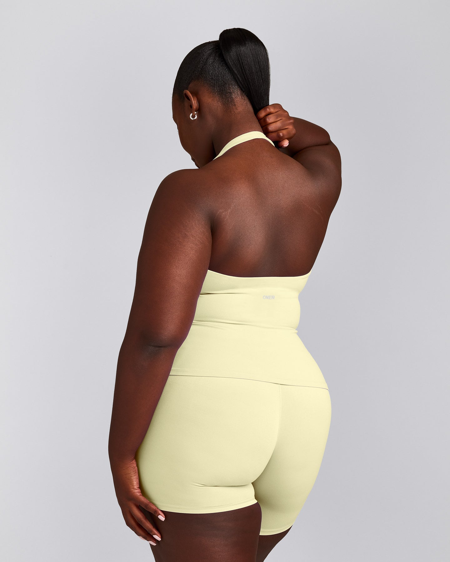 SoftMotion™ Halter Neck Tank Top with Built in Bra Shelf with Gray Logo | Pastel Yellow