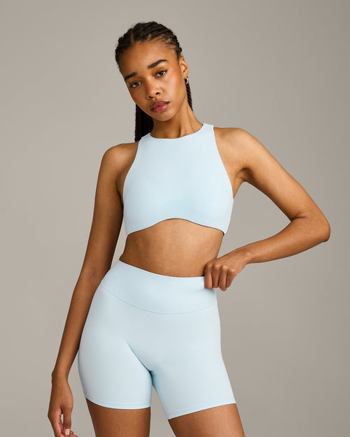 SoftMotion™ High Neck Sports Bra with Gray Logo | Cloud Blue