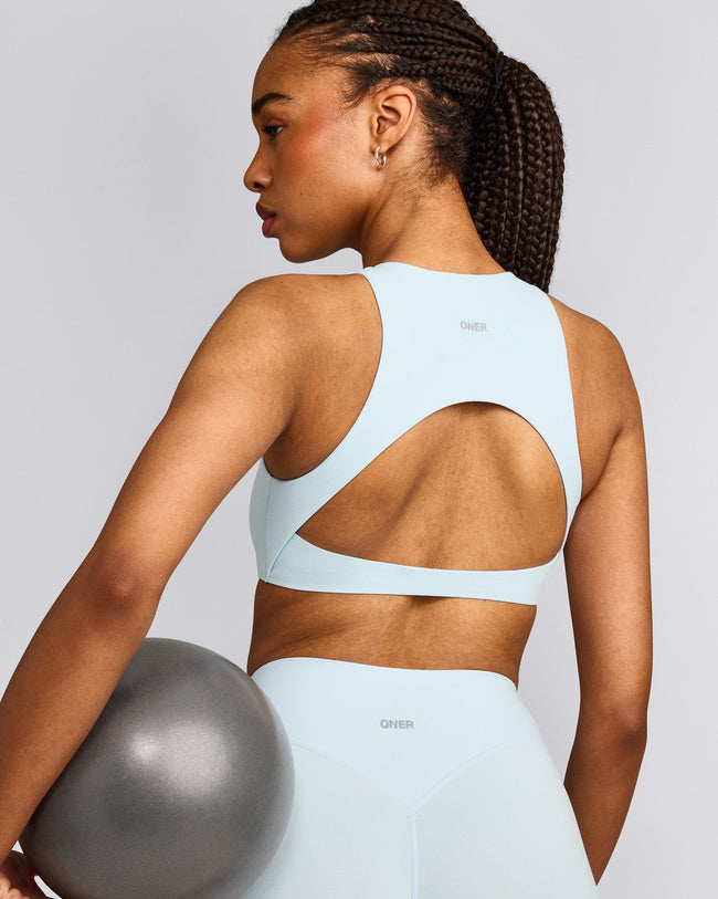 SoftMotion™ High Neck Sports Bra with Gray Logo | Cloud Blue