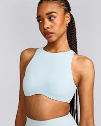 SoftMotion™ High Neck Sports Bra with Gray Logo | Cloud Blue