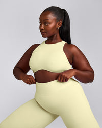 SoftMotion™ High Neck Sports Bra with Gray Logo | Pastel Yellow