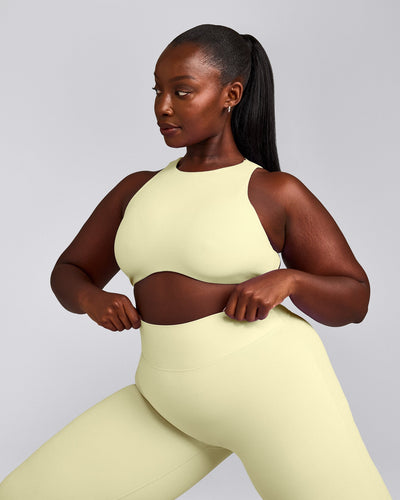 SoftMotion™ High Neck Sports Bra with Gray Logo | Pastel Yellow