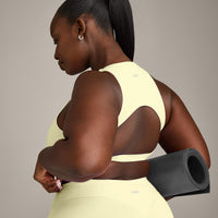 SoftMotion™ High Neck Sports Bra with Gray Logo | Pastel Yellow