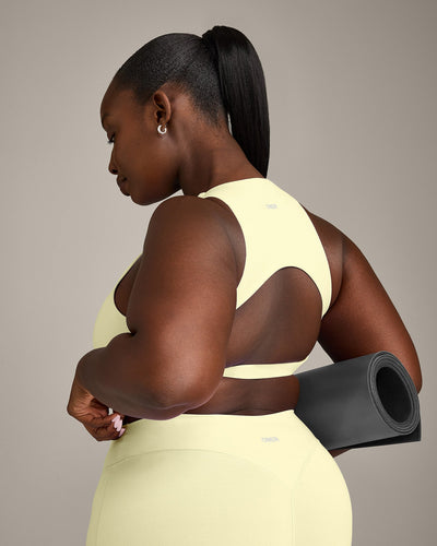 SoftMotion™ High Neck Sports Bra with Gray Logo | Pastel Yellow