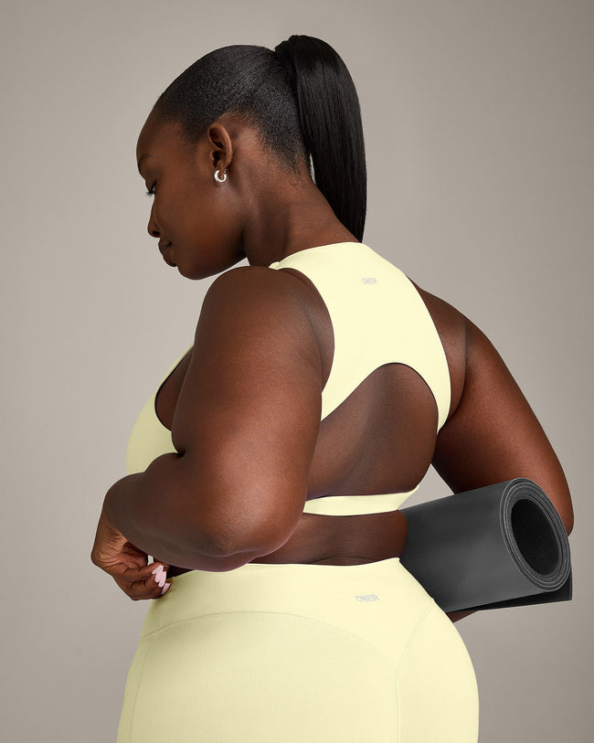 SoftMotion™ High Neck Sports Bra with Gray Logo | Pastel Yellow