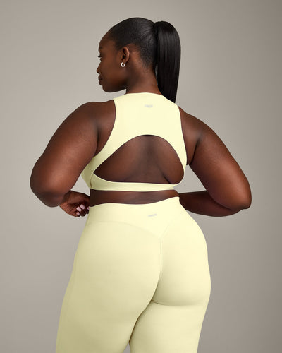 SoftMotion™ High Neck Sports Bra with Gray Logo | Pastel Yellow