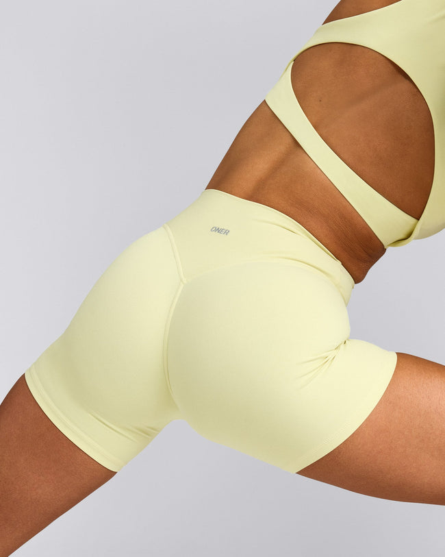 SoftMotion™ High Waisted Shorts 6" with Gray Logo | Pastel Yellow