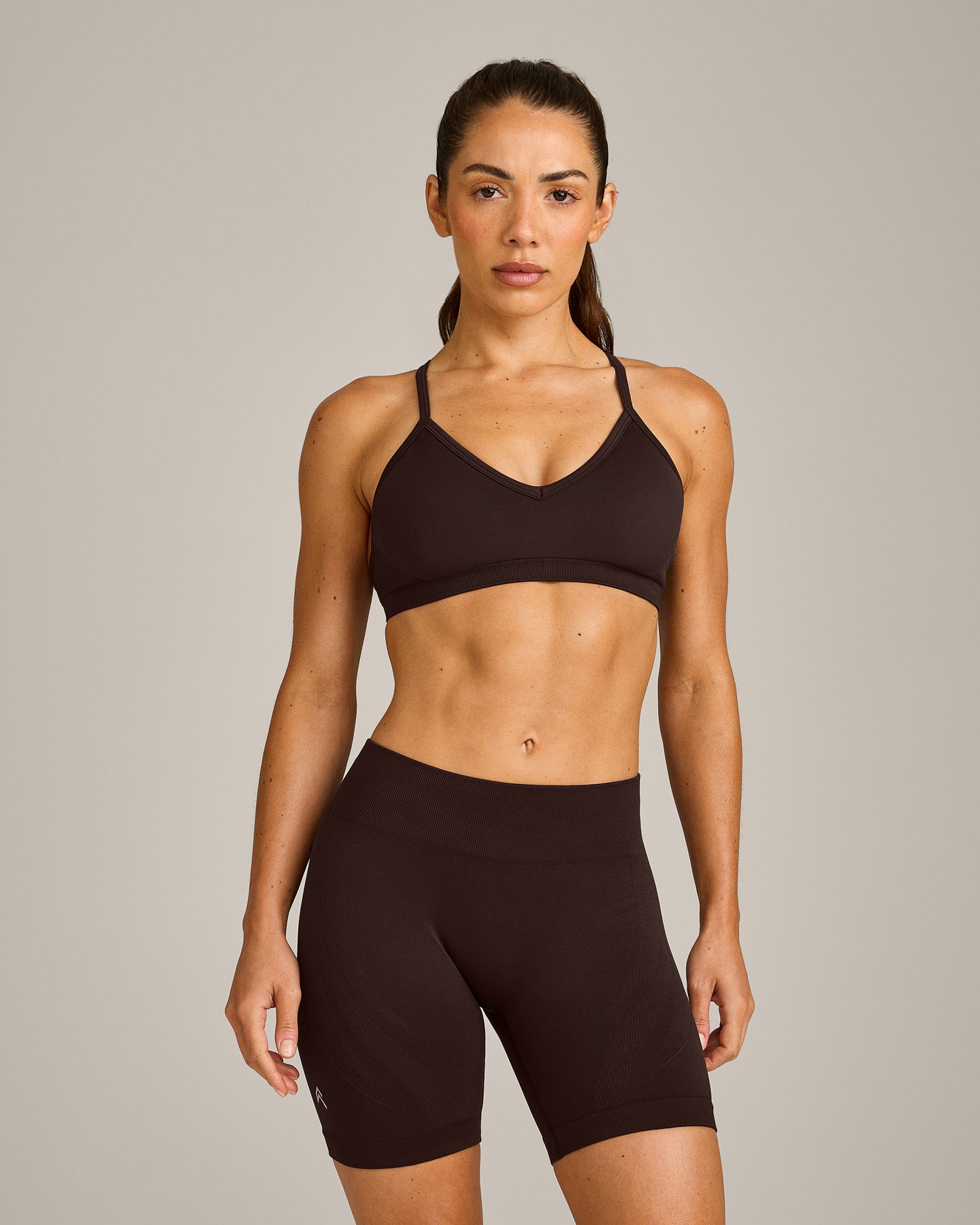 EnhanceLift™ Seamless Strappy Sports Bra with Gray Logo | 70% Cocoa