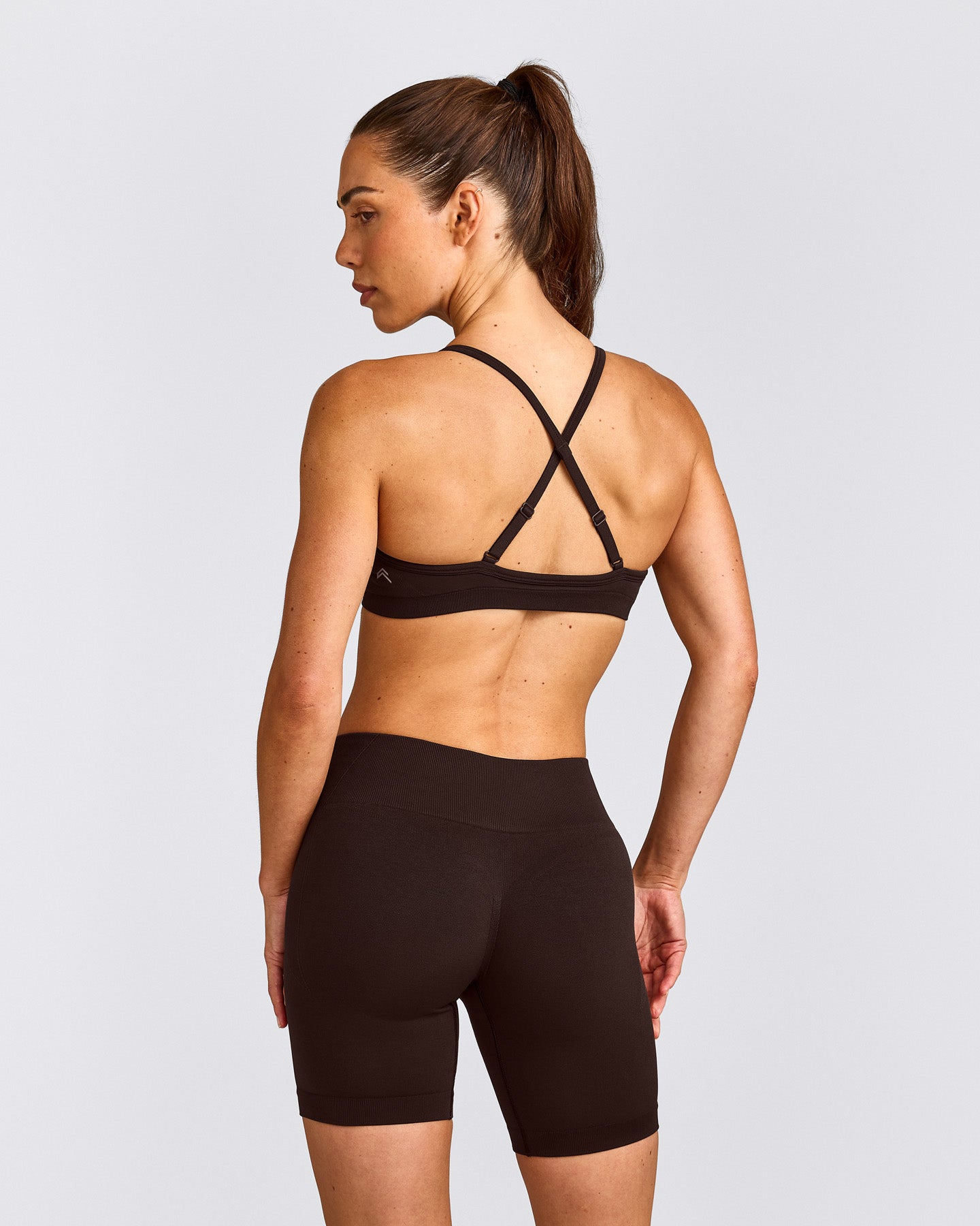 EnhanceLift™ Seamless Strappy Sports Bra with Gray Logo | 70% Cocoa