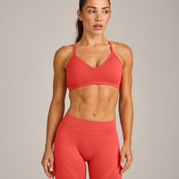 EnhanceLift™ Seamless Strappy Sports Bra with Gray Logo | Dark Charged Coral