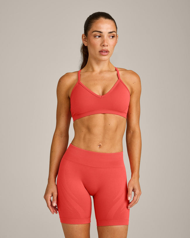 EnhanceLift™ Seamless Strappy Sports Bra with Gray Logo | Dark Charged Coral