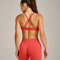 EnhanceLift™ Seamless Strappy Sports Bra with Gray Logo | Dark Charged Coral