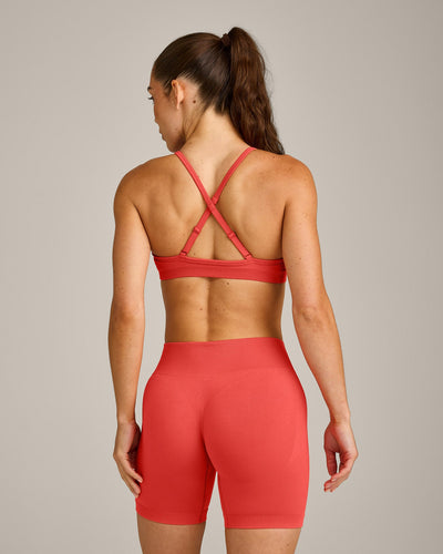 EnhanceLift™ Seamless Strappy Sports Bra with Gray Logo | Dark Charged Coral