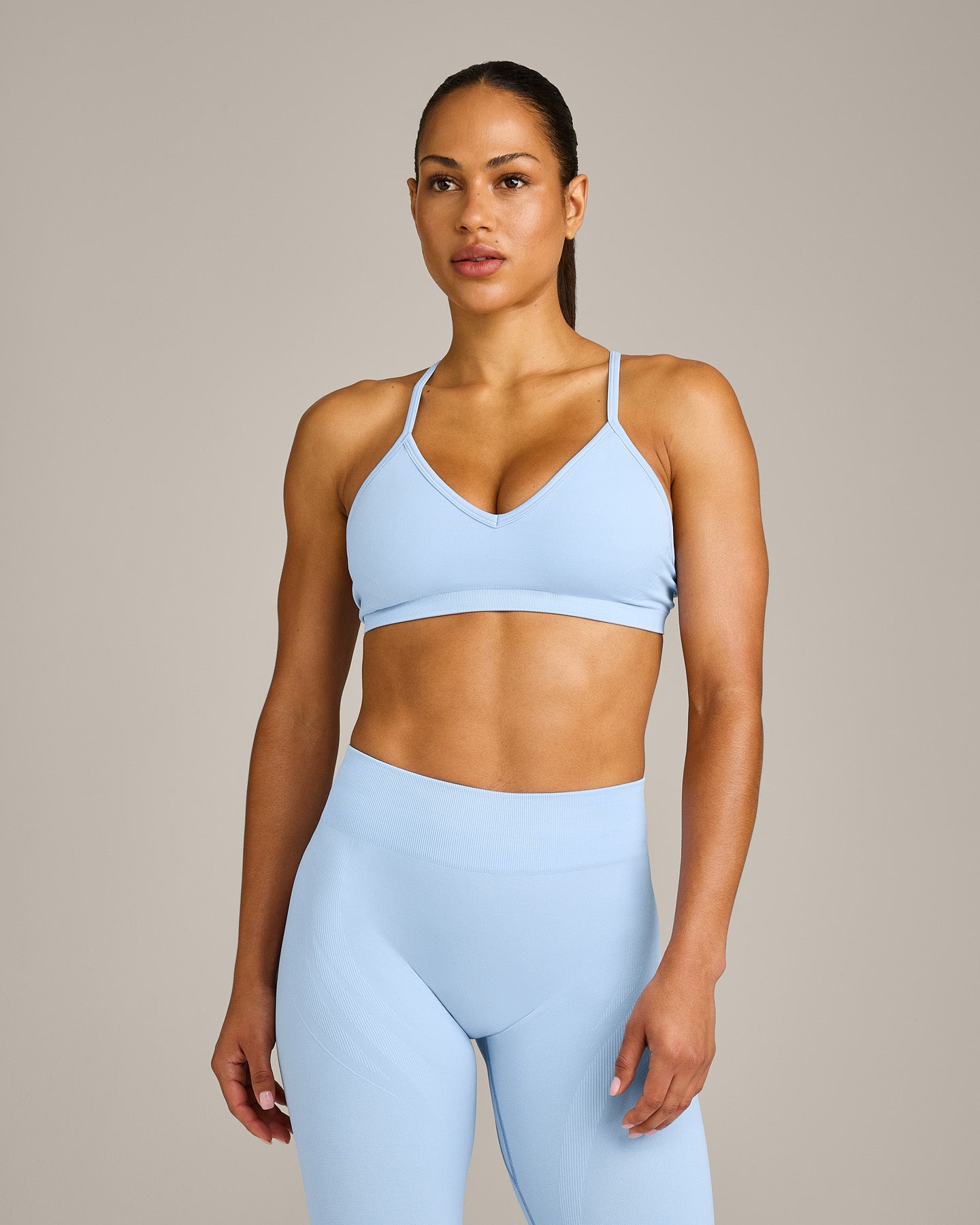 EnhanceLift™ Seamless Strappy Sports Bra with Gray Logo | Powdered Blue